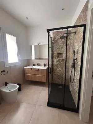 a bathroom with a shower and a toilet and a sink at Wellness House in Bagheria