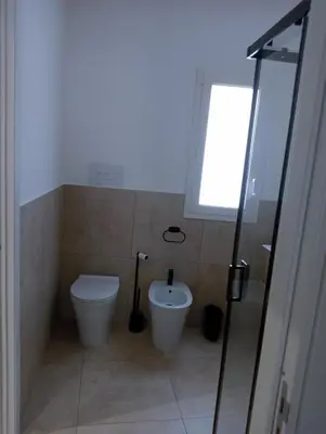 a bathroom with a toilet and a bidet at Wellness House in Bagheria