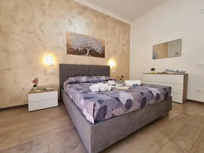 a bedroom with a bed with two towels on it at Kala Flat by Holiday World in Palermo