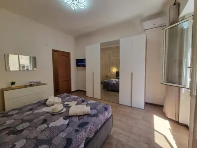 a bedroom with a large bed in a room at Kala Flat by Holiday World in Palermo
