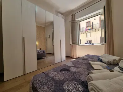 a bedroom with a bed and a large window at Kala Flat by Holiday World in Palermo