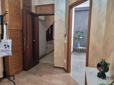 a hallway with a wooden door and a vase at Kala Flat by Holiday World in Palermo