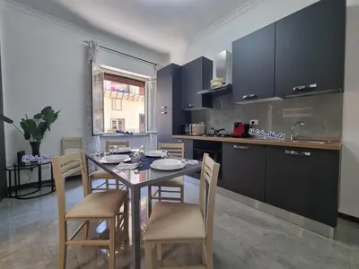 a kitchen with a table and chairs in a room at Kala Flat by Holiday World in Palermo