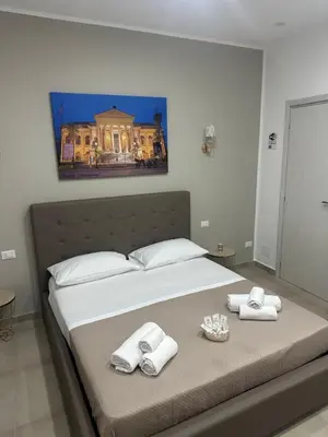 a bedroom with a bed with towels on it at Holiday home tom in Palermo