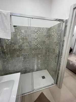 a glass shower in a bathroom with a sink at Holiday home tom in Palermo