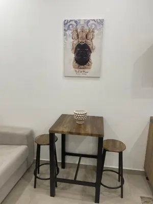 a table and two stools in a room at Holiday home tom in Palermo