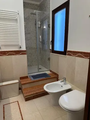 a bathroom with a shower and a toilet and a sink at Villa Oasi Bonita a Mondello in Palermo