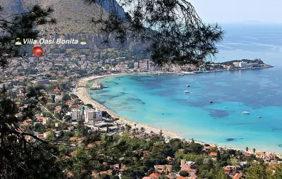 a view of a beach with buildings and the ocean at Villa Oasi Bonita a Mondello in Palermo