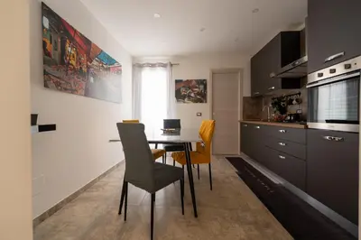 a kitchen with a dining room table and chairs at Il Palchetto in Palermo