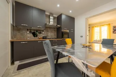 a kitchen and dining room with a table and chairs at Il Palchetto in Palermo