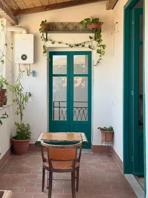 a green door on a patio with a table and chairs at Locanda Lupo in Palermo