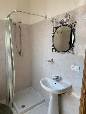 a bathroom with a sink and a mirror at Locanda Lupo in Palermo