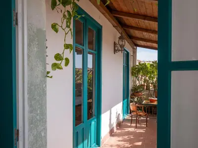 an open door to a patio with a table and chairs at Locanda Lupo in Palermo