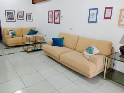 a living room with two couches and blue pillows at Casa Montalbano in Nuova Gibellina
