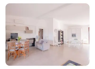 a living room with a table and chairs and a couch at Cas'aMare Holidays, Home is Love in Castellammare del Golfo