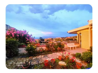 a patio with flowers and plants on a house at Cas'aMare Holidays, Home is Love in Castellammare del Golfo
