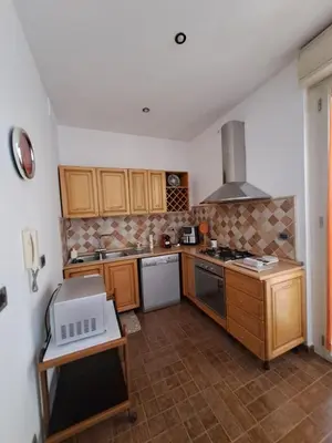 a kitchen with wooden cabinets and a stove top oven at Emily's Place in Palermo