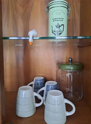 a shelf with tea cups and a jar on it at Emily's Place in Palermo
