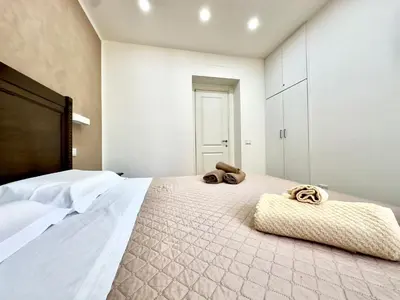 a bedroom with a bed with two towels on it at MD Apartament Coral Bahalara 2 in Palermo