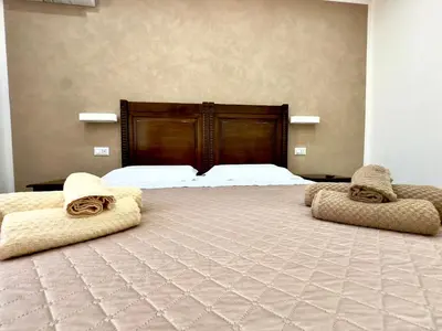 a bedroom with a large bed with towels on it at MD Apartament Coral Bahalara 2 in Palermo