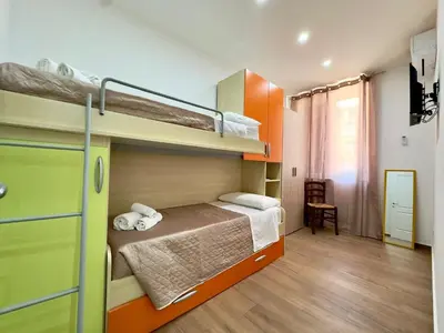 a bedroom with two bunk beds and a desk at MD Apartament Coral Bahalara 2 in Palermo