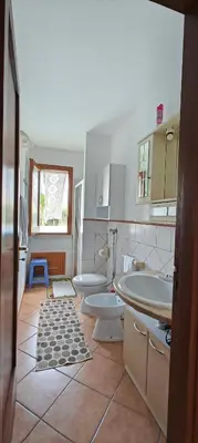 a bathroom with two sinks and two toilets at Villa Calatafimi Segesta in Calatafimi