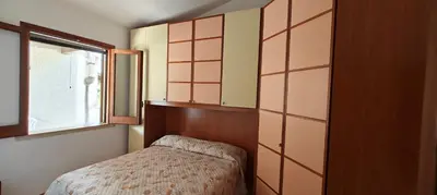 a small bedroom with a bed and a window at Villa Calatafimi Segesta in Calatafimi