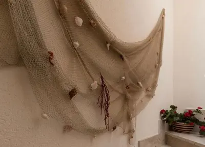 a curtain hanging on a wall with a plant at Indipendente a S vito lo Capo in San Vito lo Capo
