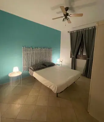 a bedroom with a bed and a ceiling fan at Indipendente a S vito lo Capo in San Vito lo Capo
