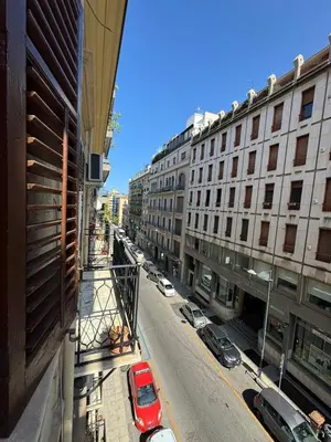 a view of a city street with parked cars and buildings at Petit Charme in Palermo
