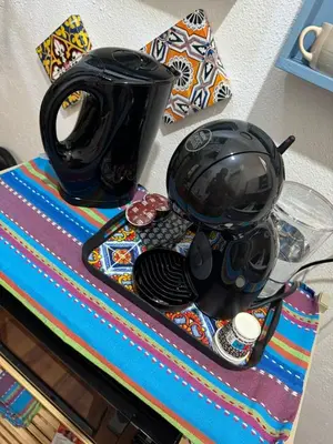 a table with a black pot and plates on it at Petit Charme in Palermo