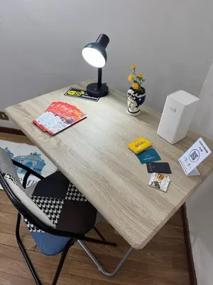 a wooden desk with a lamp and a chair at Petit Charme in Palermo