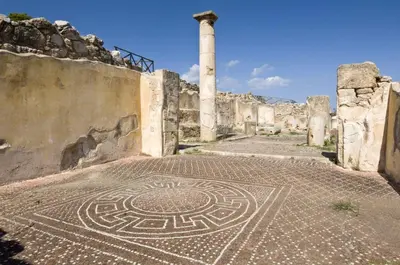 a mosaic floor in a building with a pillar at SOLUNTUM - locazione turistica in Santa Flavia