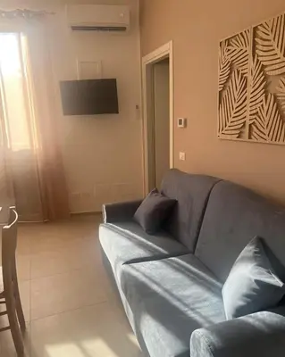 a living room with a couch and a television at Palermo Sunhouse in Palermo
