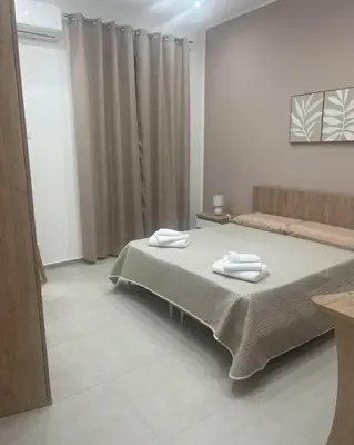 a bedroom with a bed with two towels on it at Palermo Sunhouse in Palermo