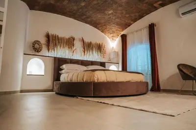 a bedroom with a large bed in a room at Zahira suite&spa in Palermo
