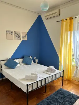 a bedroom with a blue wall and a bed at Balhara Floridi House in Palermo