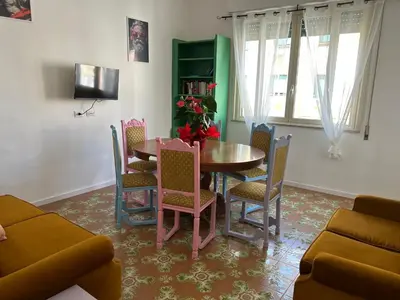 a dining room with a table and chairs at Balhara Floridi House in Palermo