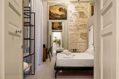 a bedroom with two beds in a room at Palazzo Cavarretta - Le Stanze dei Baroni in Palermo