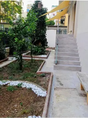 a building with stairs and a bench in a yard at B&B Magnolie in Palermo