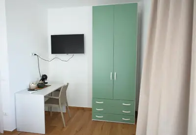 a room with a desk and a green cabinet at Magnolia Home in Terrasini
