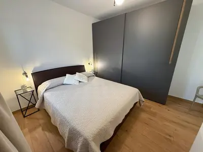 a bedroom with a bed with a white bedspread at Magnolia Home in Terrasini