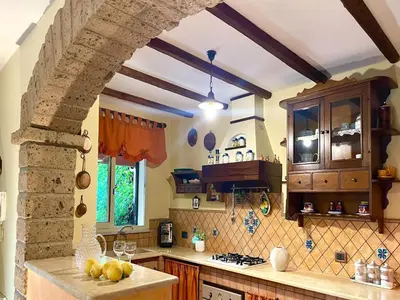 a kitchen with a stone archway and a counter top at Villa in Palermo near the Sea in Altofonte