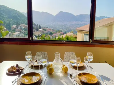 a table with glasses of wine and food on it at Villa in Palermo near the Sea in Altofonte