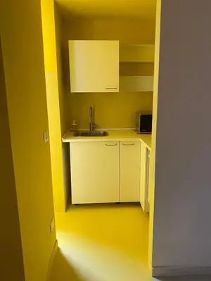 a kitchen with white cabinets and a sink in a room at Sunny Apartament in Palermo