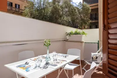 a white table and chairs on a balcony at Sunny Apartament in Palermo