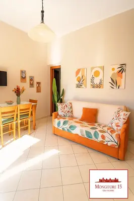 a living room with a couch and a table at Mongitore 15 in Palermo
