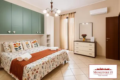 a bedroom with a bed and a dresser and a mirror at Mongitore 15 in Palermo