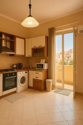a kitchen with a washing machine and a window at Mongitore 15 in Palermo