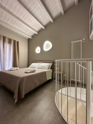 a bedroom with a bed and a crib at House Spa Palermo in Palermo